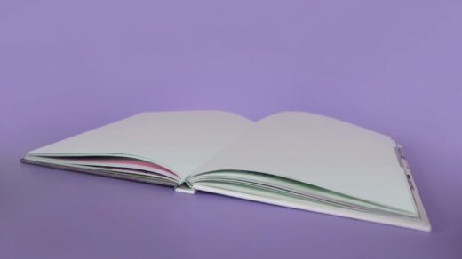 opened book on purple surface