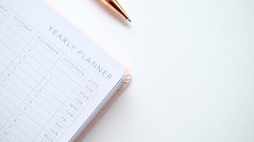 close up photo of yearly planner beside a pen